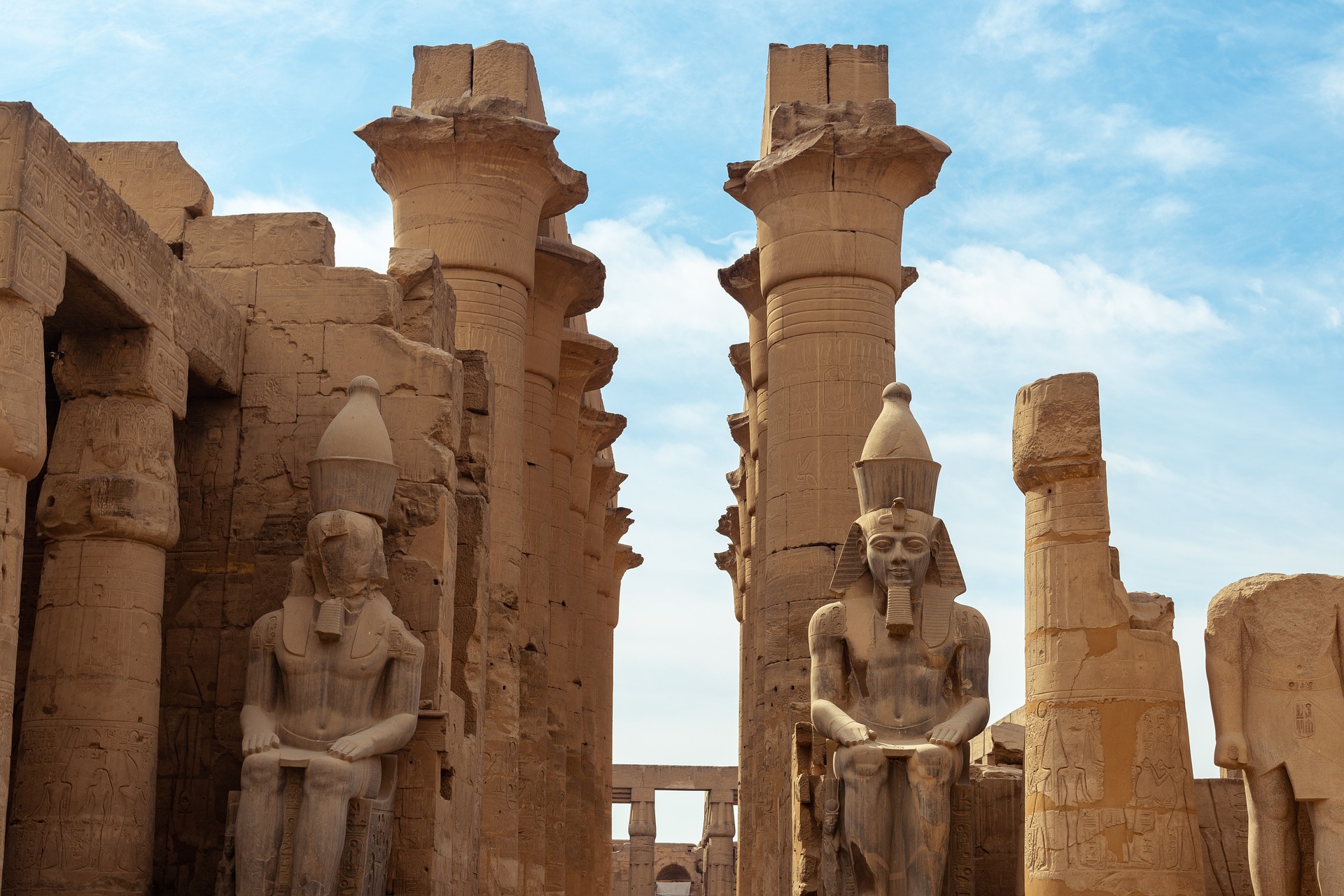  Ruins of the Luxor Temple complex, including large columns and statues of Egyptian pharaohs.